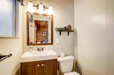 a bathroom with a sink and a toilet and a mirror at Come Snuggle Up at Cozy Bear Cabin in South Lake Tahoe