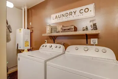 a laundry room with a washer and dryer at Come Snuggle Up at Cozy Bear Cabin in South Lake Tahoe