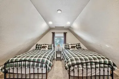 a attic bedroom with two beds and a window at Dancing Bear Cabin - Pet Friendly Sleeps 4 Totally cute in South Lake Tahoe