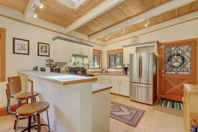 a large kitchen with a refrigerator and wooden ceilings at Shady Pines Pets Hot tub in South Lake Tahoe