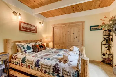 a bedroom with a bed and a wooden ceiling at Serenity Woods - Game Room & More in South Lake Tahoe