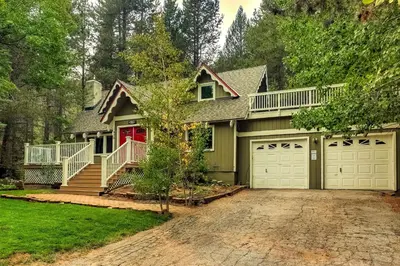 a house with a driveway and a garage at Serenity Woods - Game Room & More in South Lake Tahoe