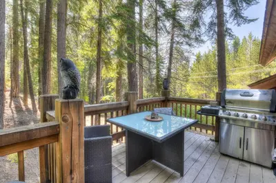 a patio with a table and a grill on a deck at Shining Shire - Sauna steam shower very cool in South Lake Tahoe