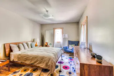 a bedroom with a large bed and a wooden floor at Shining Shire - Sauna steam shower very cool in South Lake Tahoe