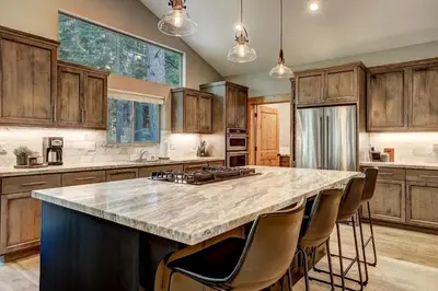 a large kitchen with a large island with bar chairs at It's a Sierra State of Mind - Family Fun in South Lake Tahoe