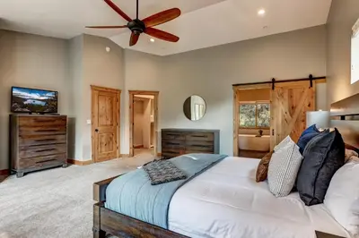 a bedroom with a bed and a ceiling fan at It's a Sierra State of Mind - Family Fun in South Lake Tahoe
