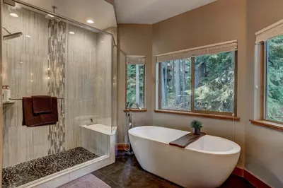 a bathroom with a bath tub and a shower at It's a Sierra State of Mind - Family Fun in South Lake Tahoe