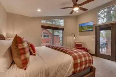 a bedroom with a bed and a ceiling fan at Silver Pines - Ski or Summer 30 plus day home in South Lake Tahoe