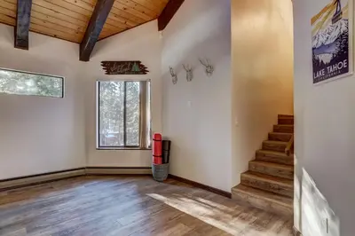 an empty room with stairs and a window at Singing Pines in Marla Bay - Walk to Lake in Glenbrook
