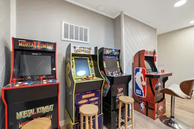 two arcade video games in a room with stools at Southern Pines Arcade Games & Foosball for Kids in South Lake Tahoe