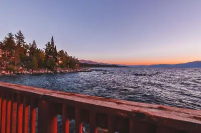 a view of the shore of a lake at sunset at Sunset Cove Chic Tahoe Retreat in Glenbrook