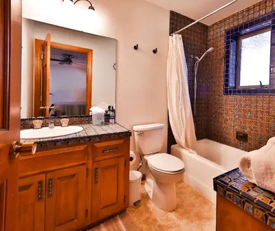 a bathroom with a sink and a toilet and a bath tub at Sunset Cove Chic Tahoe Retreat in Glenbrook