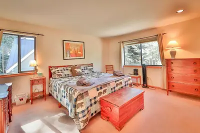 a bedroom with a bed and a dresser and windows at Tahoe Family Getaway in Stateline