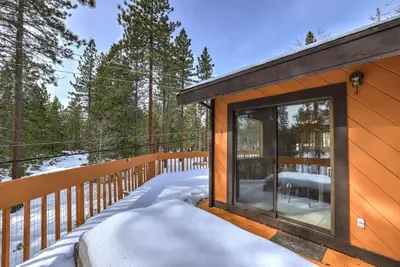 a cabin with a large window on a snowy deck at Tahoe Forest Chalet 3BR House with AC in Stateline