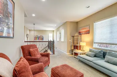 a living room with a couch and a chair at 4 Mi to The Streets of Brentwood Home with Fire Pit in Brentwood