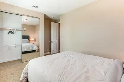 a bedroom with a bed and a mirror at 4 Mi to The Streets of Brentwood Home with Fire Pit in Brentwood