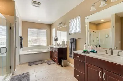 a bathroom with a tub and a sink and a shower at 4 Mi to The Streets of Brentwood Home with Fire Pit in Brentwood