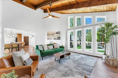 a living room with a green couch and a table at Family Retreat Mountain View with Hot Tub and Mini Golf in Steamboat