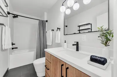 a bathroom with a sink and a toilet and a mirror at Family Retreat Mountain View with Hot Tub and Mini Golf in Steamboat