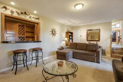 a living room with a couch and a table at Mountainside Overlook Lake Views & Hot Tub in Kings Beach