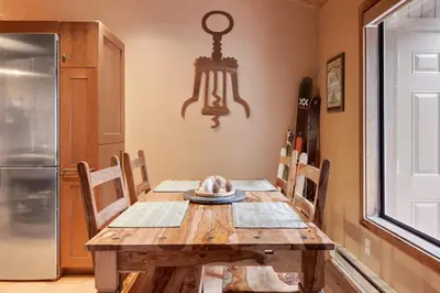 a kitchen with a wooden table and a refrigerator at North Lake Tahoe Alpine Retreat 5 Min to Skiing in Alpine Meadows