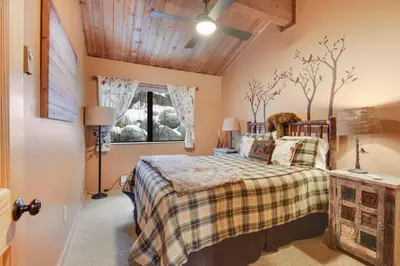 a bedroom with a bed with trees on the wall at North Lake Tahoe Alpine Retreat 5 Min to Skiing in Alpine Meadows