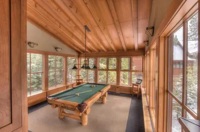 a pool table in a room with windows at Luxury Northstar Palace with Hot Tub & Games in Truckee