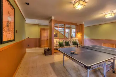 a living room with a ping pong table in it at Luxury Northstar Palace with Hot Tub & Games in Truckee
