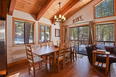 a dining room with a wooden table and chairs at Northstar Treehouse Chic 4BR House Forest view in Truckee