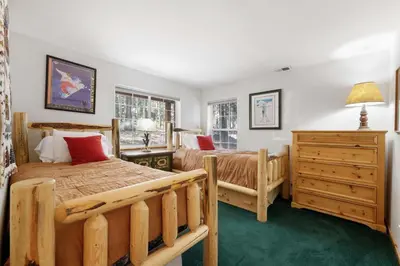 a bedroom with two beds and a dresser at Paradise Pines 3BR Secluded Cabin Minutes in Tahoe Donner in Truckee
