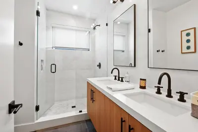 a white bathroom with a sink and a shower at Enjoy Paradise Hot Tub Bike & Beach Equipment in Olympic Valley