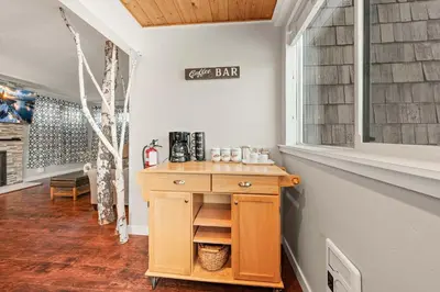 a kitchen with a wooden table and a window at Powder Run Retreat Modern Stay for 6 With On-site Ski Access & Mountain Views in Truckee
