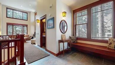 a room with a hallway with windows and a staircase at Timbers #2 townhouse in Mammoth Lakes