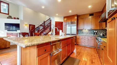 a large kitchen with wooden cabinets and a counter top at Timbers #2 townhouse in Mammoth Lakes