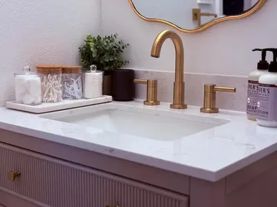 a bathroom counter with a sink and gold faucet at Downtown-Pool,Firepit,Trees, WFH-No gate fee like PML in Groveland