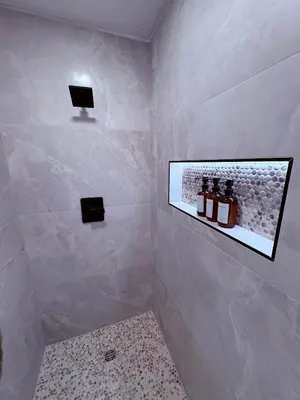 a bathroom with a shower with two monitors on the wall at Downtown-Pool,Firepit,Trees, WFH-No gate fee like PML in Groveland