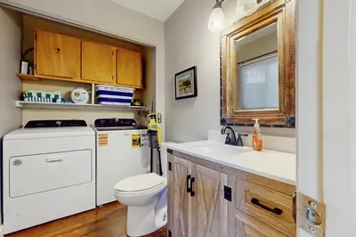 a bathroom with a sink and a washer and dryer at The Tahoe Nest in Incline Village