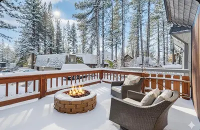 a deck with two chairs and a fire pit at The Tahoe Nest in Incline Village