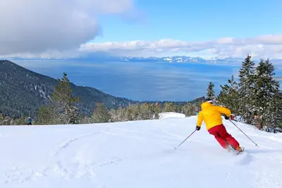 a person is skiing down a snow covered slope at The Tahoe Nest in Incline Village
