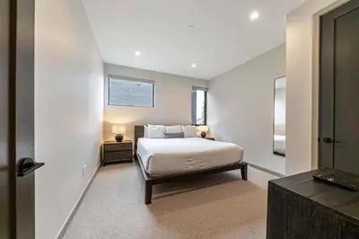 a bedroom with a bed and a television in it at Village Walk 7470 by East West Hospitality in Truckee