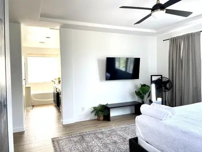 a bedroom with a bed and a tv on a wall at Huge Home near Old Folsom Pet & Family Friendly in Folsom