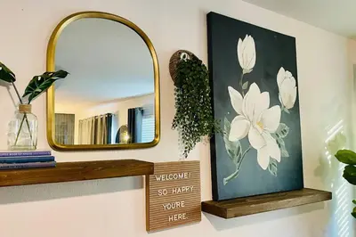 a mirror on a wall with a picture of flowers at Remodeled Excellent Neighborhood in Roseville