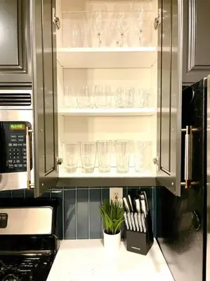 a kitchen with glasses on shelves in a cabinet at Remodeled Excellent Neighborhood in Roseville