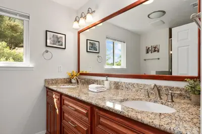 a bathroom with a sink and a mirror at Rivertop Hideaway in Ahwahnee