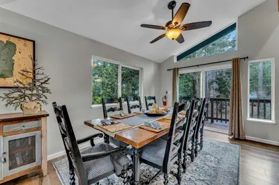 a dining room with a table and chairs and a ceiling fan at Tahoma Family Getaway with Bocce Ball & BBQ Grill in Tahoma