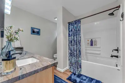 a bathroom with a sink and a tub and a shower at Tahoma Family Getaway with Bocce Ball & BBQ Grill in Tahoma