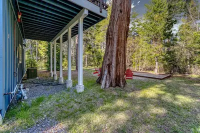 a tree sitting on the side of a house at Tahoma Family Getaway with Bocce Ball & BBQ Grill in Tahoma