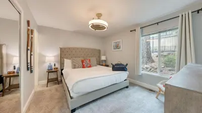 a bedroom with a large bed and a window at Ski Way by AvantStay Cozy Tahoe Home w Fireplace Balcony in Incline Village