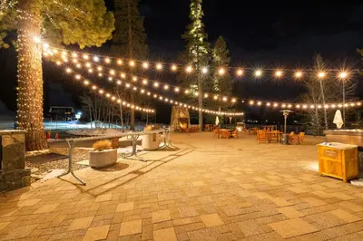 a string of lights over a patio at night at Everline Resort & Spa Palisades- Forest View in Olympic Valley