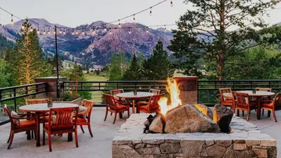 a patio with tables and chairs and a fire pit at Everline Resort & Spa Palisades- Valley View in Olympic Valley
